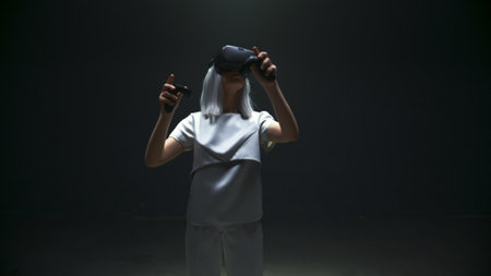 Fashionable girl playing vr game in blinking light. Futuristic gamer experience console simulation...