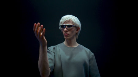 Futuristic man experiencing virtual reality closeup. Cyber teenager gesturing select simulation...