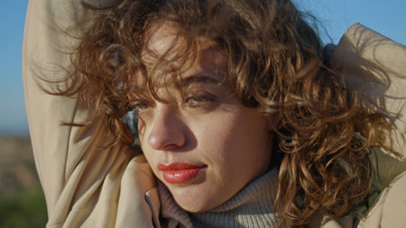 Peaceful girl relaxing stretching outdoors closeup. Serene woman enjoy sunlight windy evening walk....