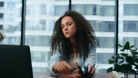 Unsatisfied woman closing laptop nervously reading bad news close up. Disappointed latina merican businesswoman worried about business failure. Tired upset girl manager turned to window feeling upset.の写真素材