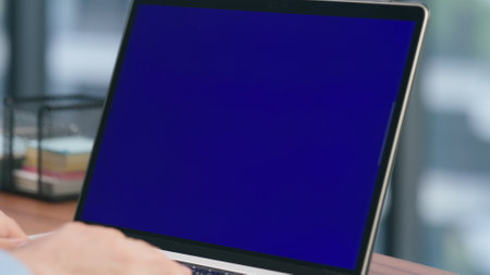 Closeup boss hands typing chromakey laptop keyboard. Unknown businessman pushing buttons on blue screen computer. Unrecognizable man using mockup device at modern workplace. Technologies conceptの写真素材