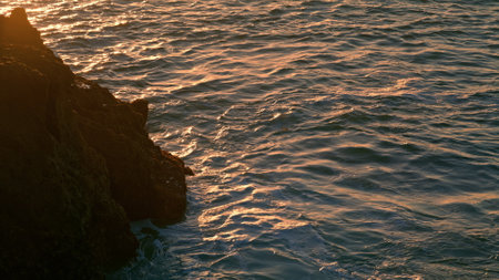 Calm water washing mountain at morning closeup. Tranquil waves moving surface at sunbeams nature....