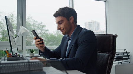 Upset man calling mobile at office workplace. Stressed manager thinking problems leaning chair. Frustrated businessman ponder financial personal issues covering face with hands. Work overload conceptの写真素材