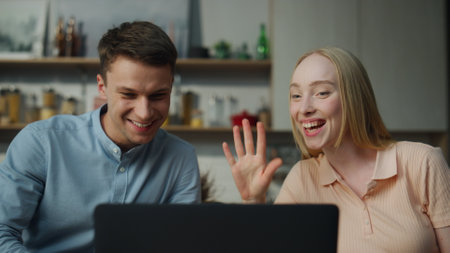 Young married couple talking on video call from home sitting kitchen close up. Happy distance...