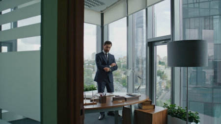 Middle-aged bearded boss worried company work standing modern office with crossing hands. Serious business man thinking about making deal financial results corporate crisis. Ceo manager contemplating.の写真素材
