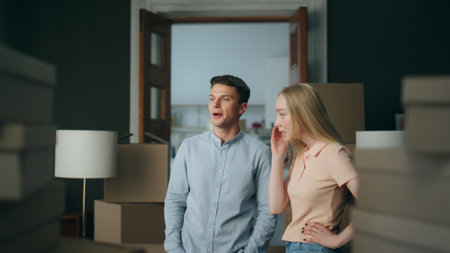 Annoyed married pair disputing at home close up. Grumpy blond wife shouting on nervous husband gesturing emotionally. Irritated man discussing about misunderstanding. Breakup divorce concept.の写真素材
