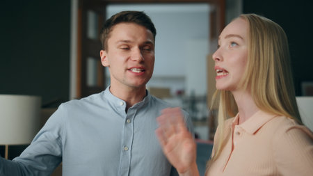 Emotional family conflict at home closeup. Angry man arguing loudly with nervous woman feeling aggression. Young husband shouting at wife dissatisfied with relationship. Marriage crisis concept.の写真素材