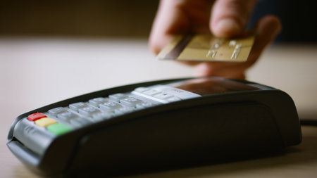 Contactless credit card payment on bank terminal close up. Man hand paying for purchase with NFC...