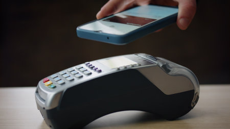 Contactless payment by bank terminal using modern smartphone with nfc technologies close up. Unknown...