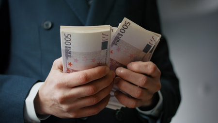 Man hands counting european banknotes indoors close up. Unknown successful businessman calculating pack of bills denomination five hundred euro. Rich finansist holding lot of cash. Business concept.の写真素材