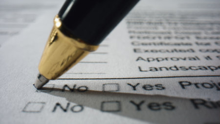 Closeup pen filling questionnaire on white paper. Unknown person writing marks on checklist document answering questions. Ballpoint putting checkboxes passing test. Paperwork survey form concept.の写真素材
