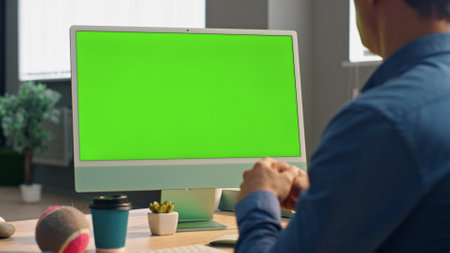 Manager talking mockup computer display at video call modern office. Closeup unknown specialist looking green screen gesturing hands at work place. Confident man designer communicating at virtual chatの写真素材