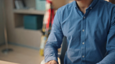 Closeup man hands typing keyboard at office. Focused overworked businessman working computer pushing buttons at table workplace. Tired designer rubbing eyes sitting alone at cabinet room interiorの写真素材