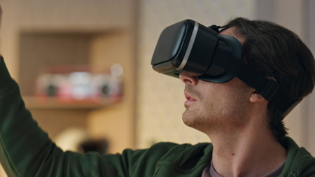 Closeup designer touching metaverse at room. Modern 3d developer using virtual reality glasses replacing invisible objects. Vr headset programmer creating computer game enjoying futuristic interfaceの写真素材
