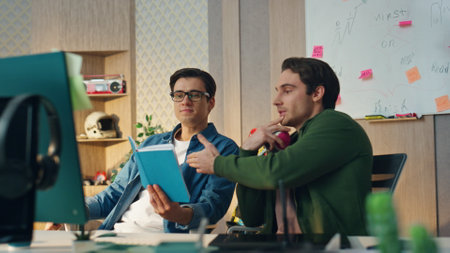 Smiling workers speaking virtual meeting in modern office. Closeup satisfied businessmen feeling relaxed having successful negotiation online. Happy company owners talking on web camera togetherの写真素材