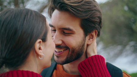 Portrait of happy couple in love enjoying romantic date at nature. Attractive sensual woman kissing bearded man outdoors close up. Tender lovers hugging feeling closeness in park. Relationship conceptの写真素材