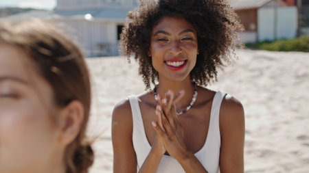 Smiling girl enjoying beach with lgbt partner closeup. Happy african american adjusting touching black curly hair. Joyful stylish woman enjoy summer weekend at ocean shore. Coastline holiday conceptの写真素材