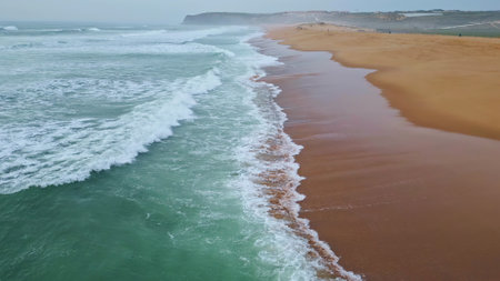 Gloomy marine surf nature slow motion. Serene sea coast with foaming grey waves closeup. Picturesque deep ocean landscape. Swell rolling empty seashore. Dusk water surface in overcast summer weatherの写真素材