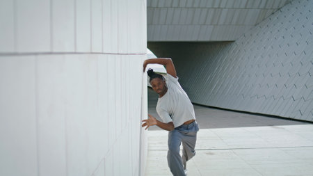 Artistic guy dancing contemp urban place closeup. African american dancer performing choreography outdoors. Brown skin man training enthusiastic dance contemp at summer day. Street subculture conceptの写真素材