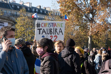 Paris, France - November 28th 2020: at the march against the global security law, protesters olding Ã  sign urging Christian Taubira to run for the presidency