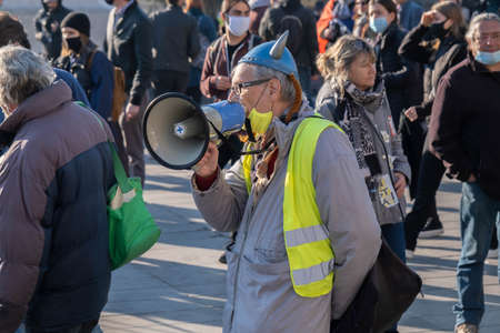 Paris, France - November 28th 2020: at the march against the global security law, a yellow jacket wearing a gallic helmet shouting in a megaphoneのeditorial素材