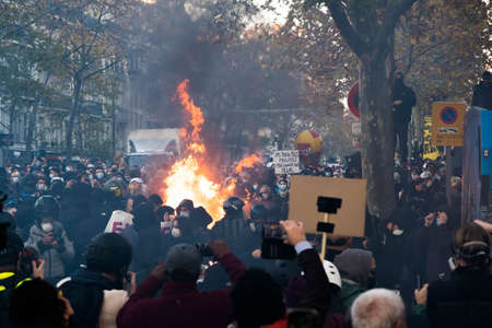Paris, France - November 28th 2020: at the march against the global security law, protesters burning...