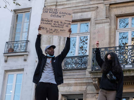 Paris, France - November 28th 2020: at the march against the global security law, two people wearing...