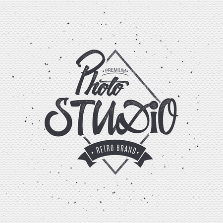 Photo studio badge insignia, monochrome using geometric shapes assembled in typographic elements on textured background worn paperのイラスト素材