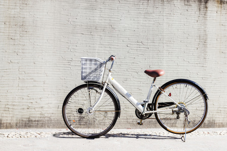 bicycle with basket in front of the white wall, backgroundの写真素材