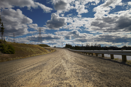 Desert road with cloudy sky in Canadaの写真素材