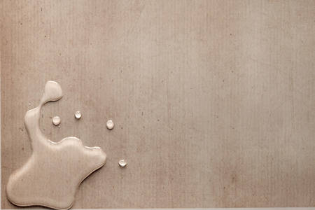 splash drops on carton piece of paperの写真素材