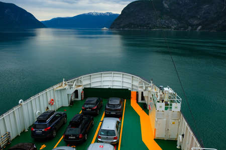 Peoples and vehicles on a ferry boat the ferry ship across Sognefjord, Norway. Public transport by ferry transports more than 8 million passengers annually.のeditorial素材