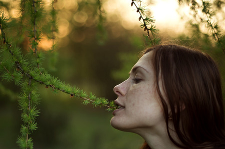 vegetarian girl eating green leaves on the treesの写真素材