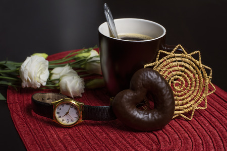 cup of coffee and cookies with flowersの写真素材