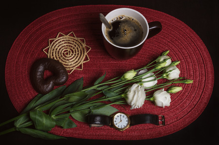 cup of coffee and cookies with flowersの写真素材