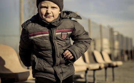 little boy playing on the sport playground for mesh fenceの写真素材