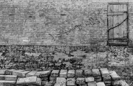 abandoned textured wall with door in black and white colorsの写真素材