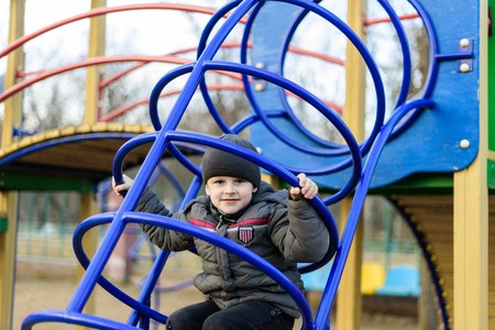 baby riding on the swing and playing on the playground