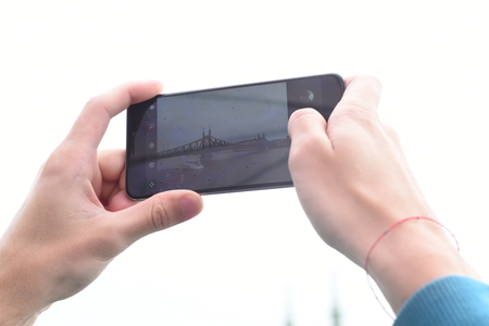 Photograph on mobile phone buildings and bridgesの写真素材