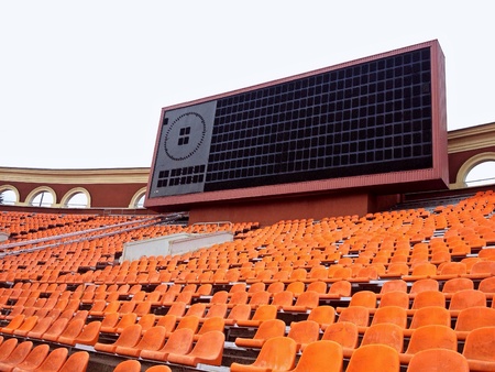 Score board and rows of seats at old football stadiumの素材