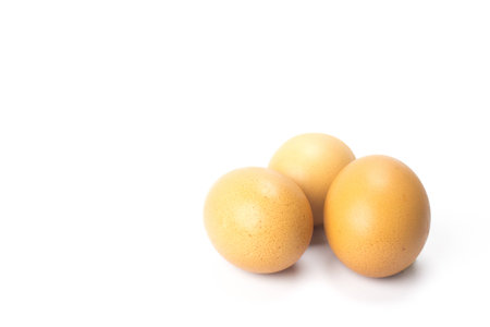 Three brown chicken egg isolated on whiteの写真素材