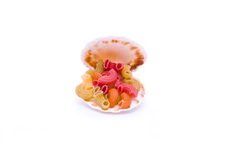 colored macaroni and seashell isolated on whiteの写真素材