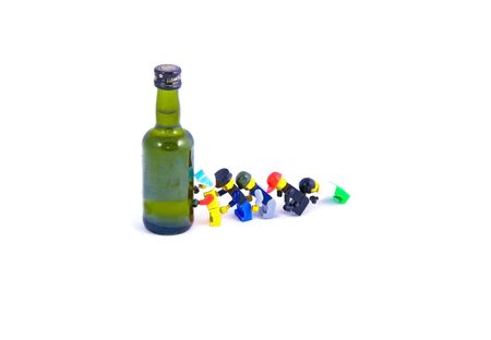 alcoholic personal degradation green bottle and plastic toysの写真素材
