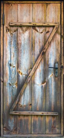 vintage boarded up funny wooden door with standart  door lockの写真素材