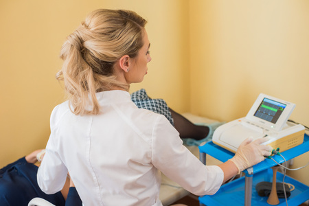 Beautiful gynecologist does cardiotocography of the fetus. A young doctor examines a patien. Checkup.の写真素材