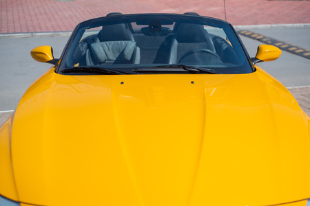Long yellow hood sports two-seater convertible. Close upの写真素材