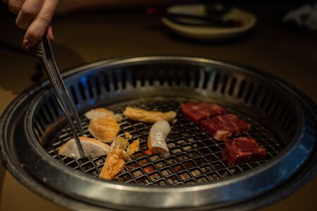 Fresh meat. Grilling meat in a Korean restaurant. Traditional Korean foodの写真素材