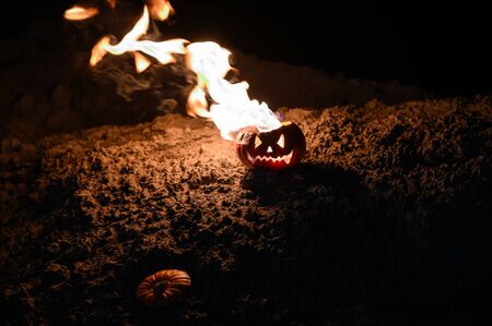 Tongues of flame in a pumpkin. jack-o-lantern on fire on a black background. Halloween symbol on the...