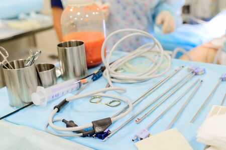 Plastic surgery to remove excess fat. Pumping fat into a jar during liposuction. Surgical instruments for liposuction in the operating room.の写真素材