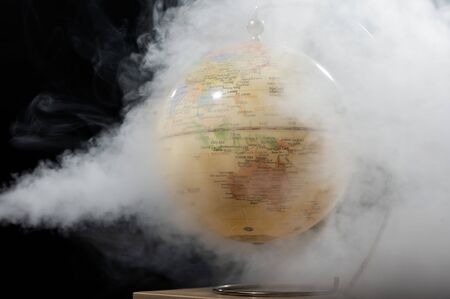 White Smoke Cover Around the World Globe. Globe in puffs of smoke depicts a polluted atmosphere and...